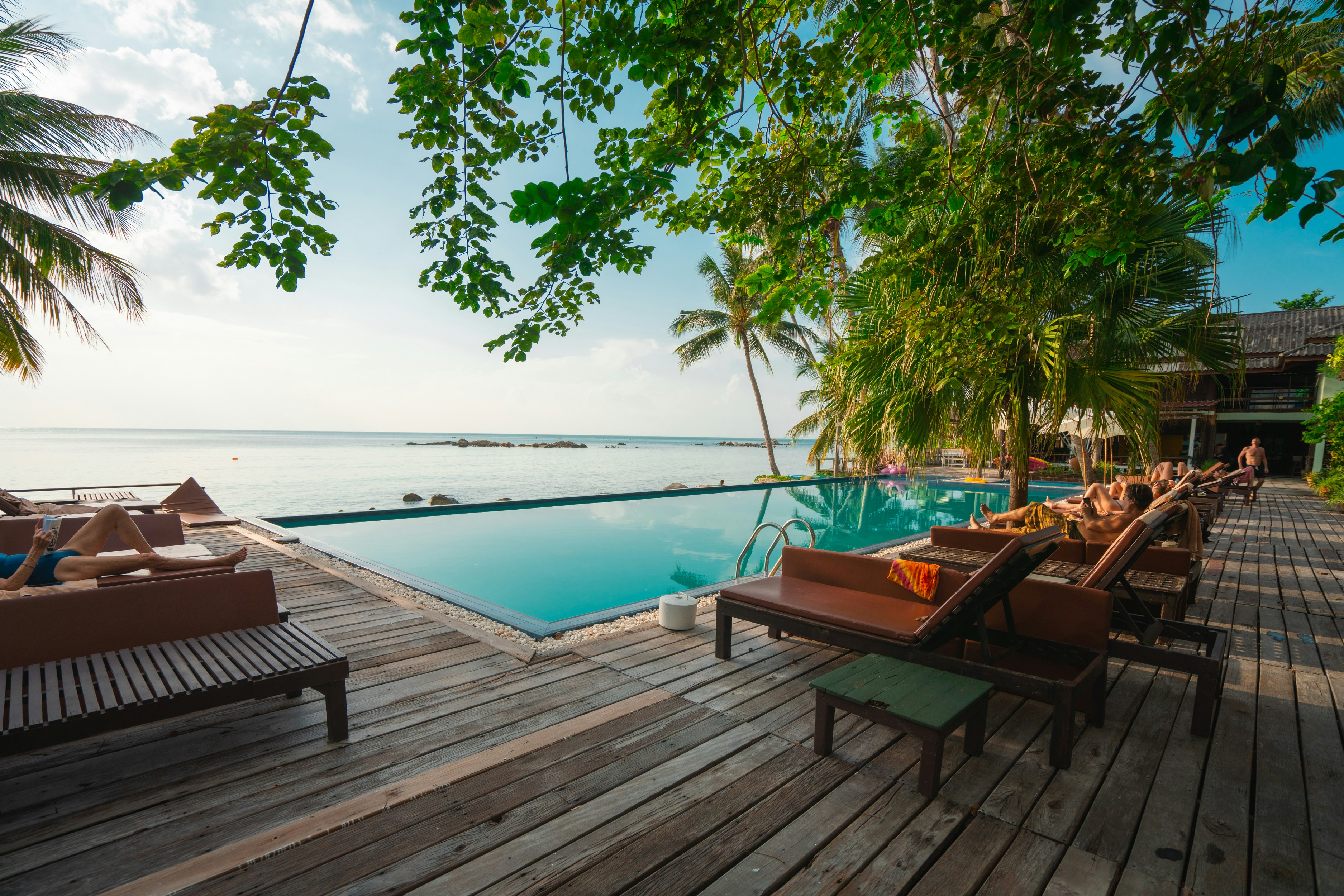 Wood-deck pool with ocean sunset